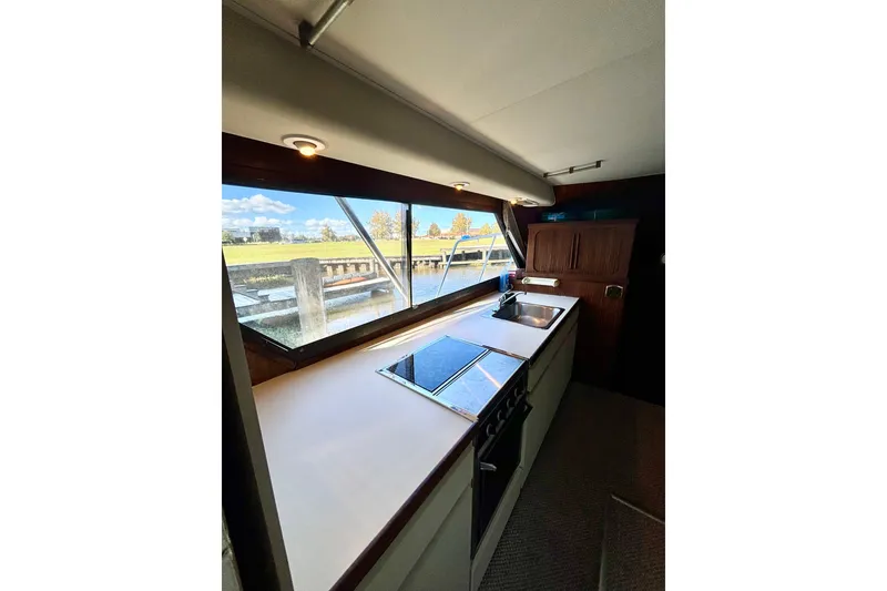 Slide: The Image of Interior view of 1986 Hatteras 41 Convertible yacht kitchen with large windows. - 28