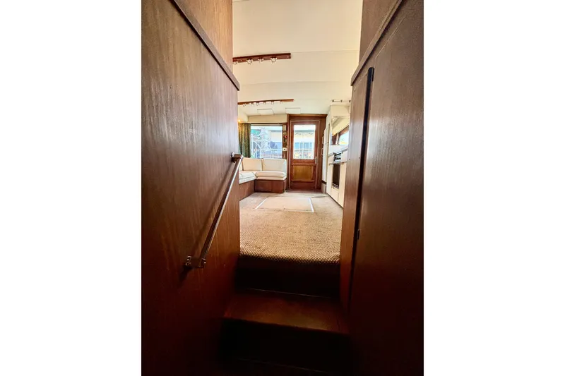 Slide: The Image of Interior view of 1986 Hatteras 41 Convertible yacht, featuring cozy seating and wooden finishes. - 29