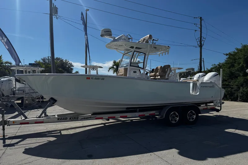 Slide: The Image of 2018 Sportsman Open 282TE Center Console boat on trailer, parked outdoors. - 1