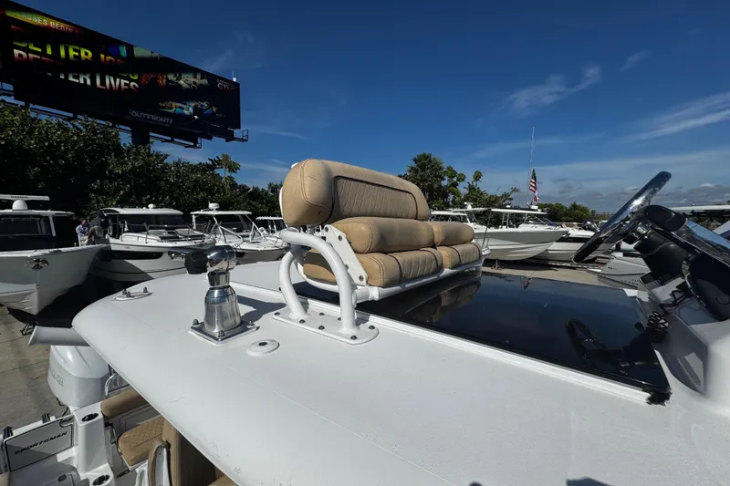 Slide: The Image of 2018 Sportsman Open 282TE Center Console boat with tan seating, docked under clear skies. - 13