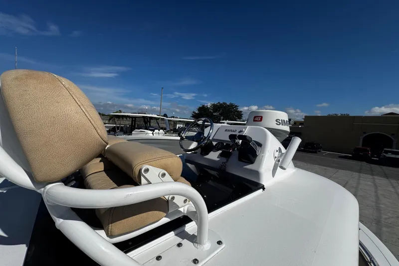 Slide: The Image of 2018 Sportsman Open 282TE Center Console boat with beige seating and navigation equipment. - 14