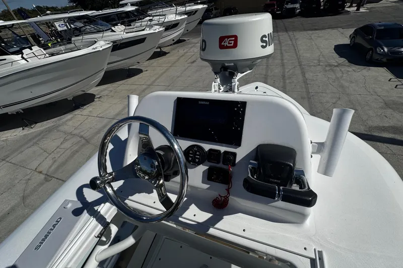 Slide: The Image of 2018 Sportsman Open 282TE Center Console boat dashboard with steering wheel and navigation equipment. - 15