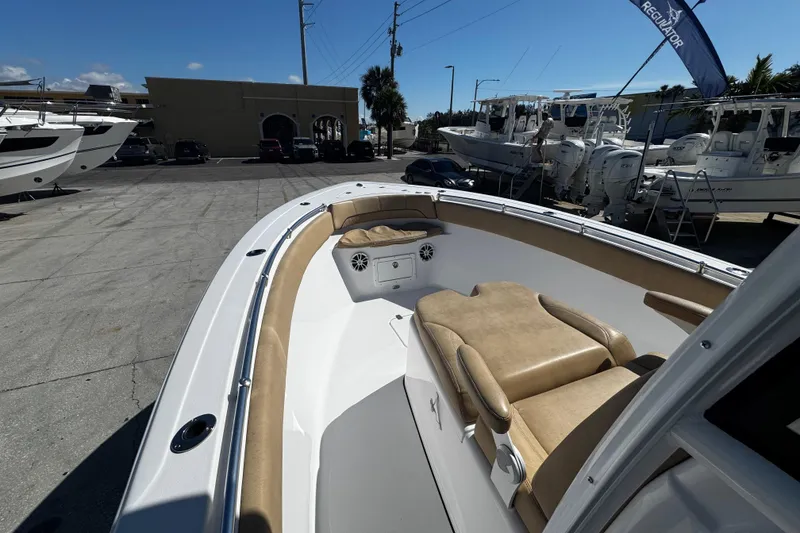 Slide: The Image of 2018 Sportsman Open 282TE Center Console boat with tan seating, docked at a marina. - 6