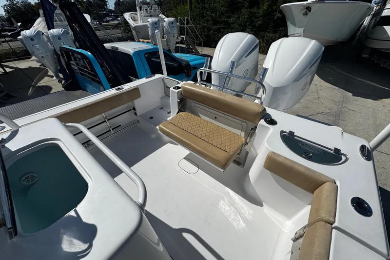 Slide: The Image of 2018 Sportsman Open 282TE Center Console boat interior with seating and dual engines. - 8