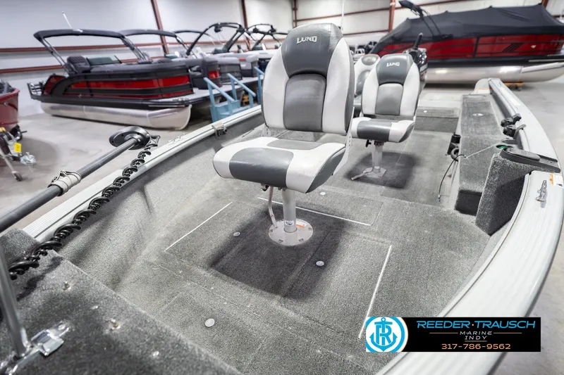 Slide: The Image of 2007 Lund 1600 Explorer SS boat interior with two seats in a showroom. - 11