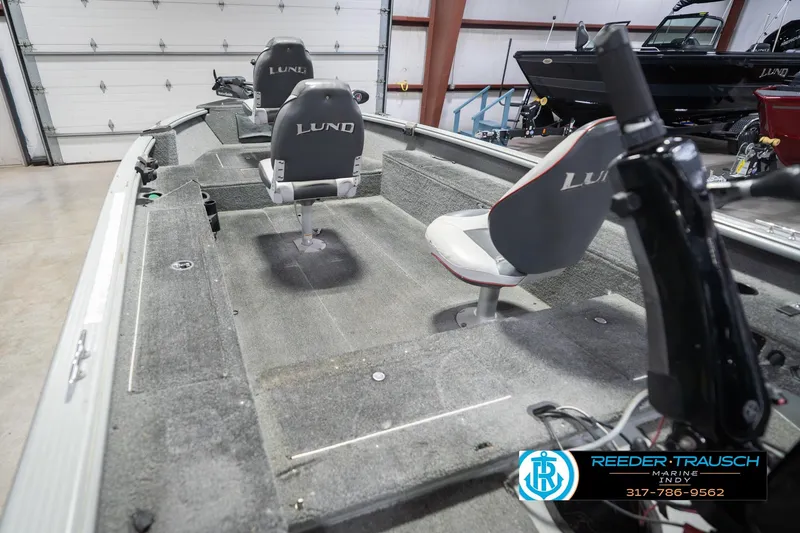 Slide: The Image of 2007 Lund 1600 Explorer SS boat interior with two seats in a garage setting. - 14