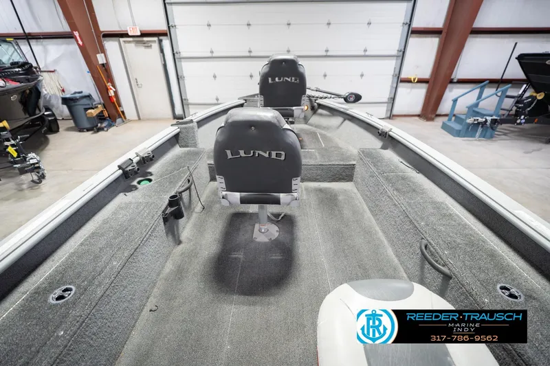 Slide: The Image of 2007 Lund 1600 Explorer SS boat interior in a garage setting. - 15