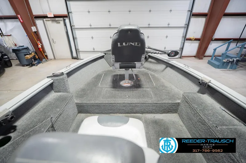 Slide: The Image of 2007 Lund 1600 Explorer SS boat interior in a garage setting. - 16