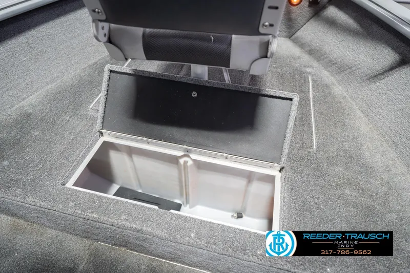 Slide: The Image of 2007 Lund 1600 Explorer SS boat storage compartment, gray interior, Reeder-Trausch Marine logo. - 27