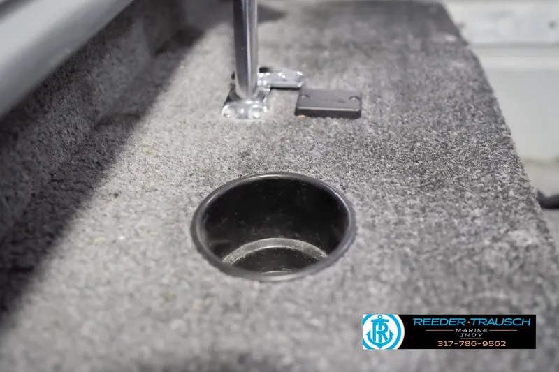 Slide: The Image of 2007 Lund 1600 Explorer SS boat interior with cup holder and carpeted surface. - 35