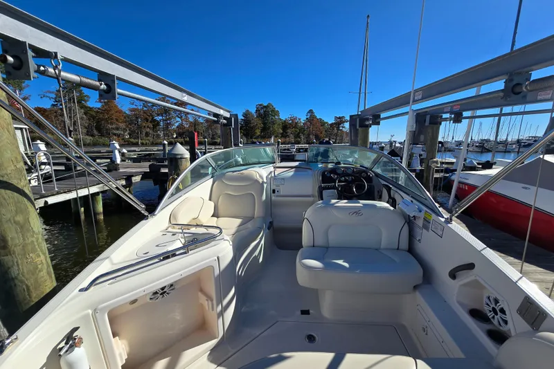 Slide: The Image of 2007 Monterey 250 Cruiser boat interior at marina, featuring seating and steering wheel. - 15