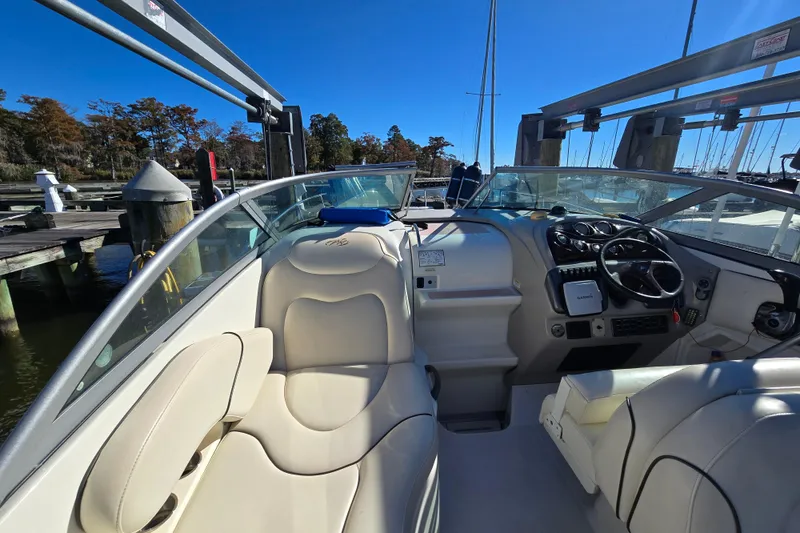 Slide: The Image of 2007 Monterey 250 Cruiser interior with beige seating and modern dashboard at marina. - 16