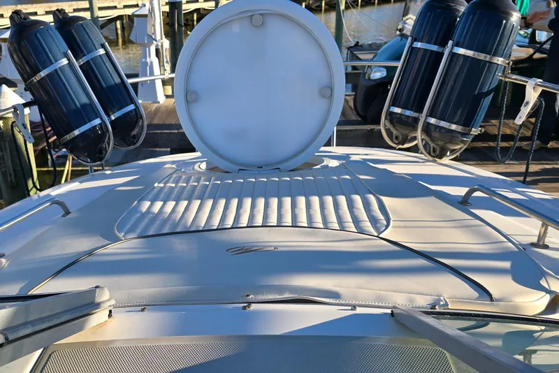 Slide: The Image of 2007 Monterey 250 Cruiser boat deck with fenders and hatch, docked at marina. - 23