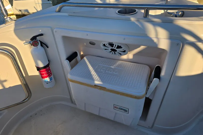 Slide: The Image of 2007 Monterey 250 Cruiser boat interior with cooler and fire extinguisher. - 24