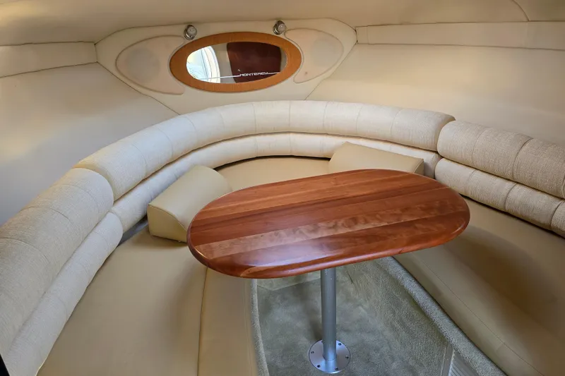 Slide: The Image of Luxurious interior of 2007 Monterey 250 Cruiser with elegant wood table and plush seating. - 28
