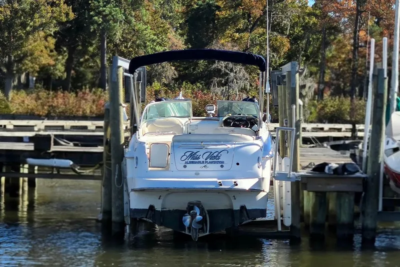 Slide: The Image of 2007 Monterey 250 Cruiser docked at a marina with autumn foliage in the background. - 3