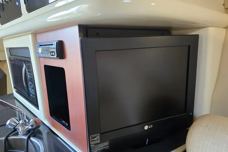 Slide: The Image of 2007 Monterey 250 Cruiser interior with TV, microwave, and sink. - 32