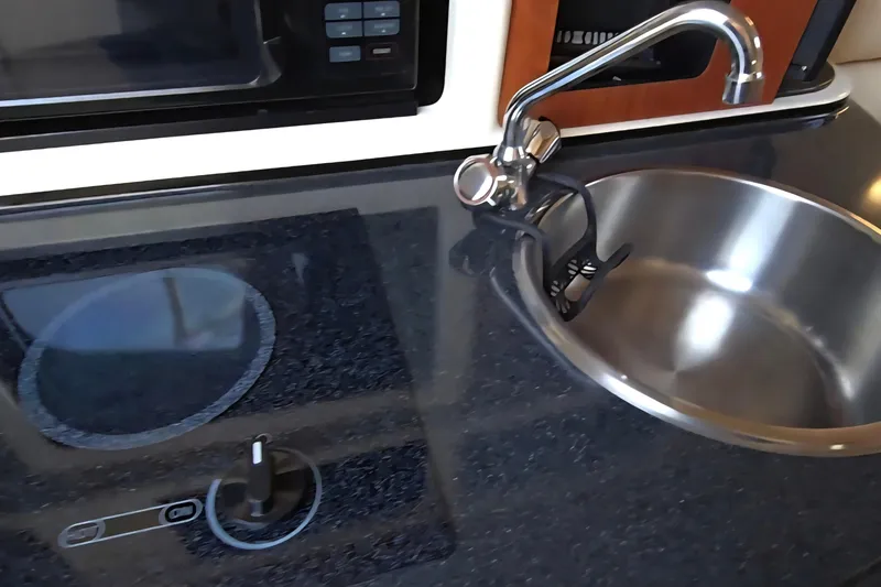 Slide: The Image of 2007 Monterey 250 Cruiser kitchen with sink, faucet, and stovetop. - 35