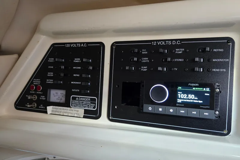 Slide: The Image of Control panel of a 2007 Monterey 250 Cruiser boat with AC and DC switches. - 36