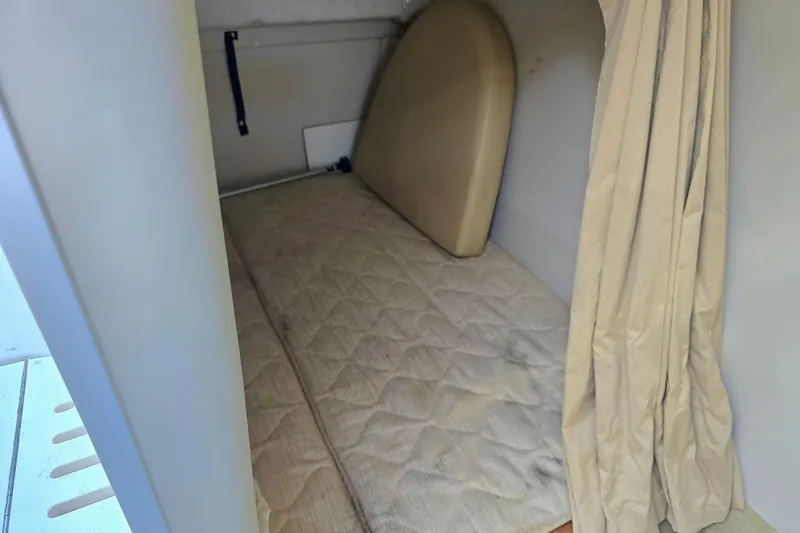 Slide: The Image of 2007 Monterey 250 Cruiser cabin interior with mattress and curtain. - 37