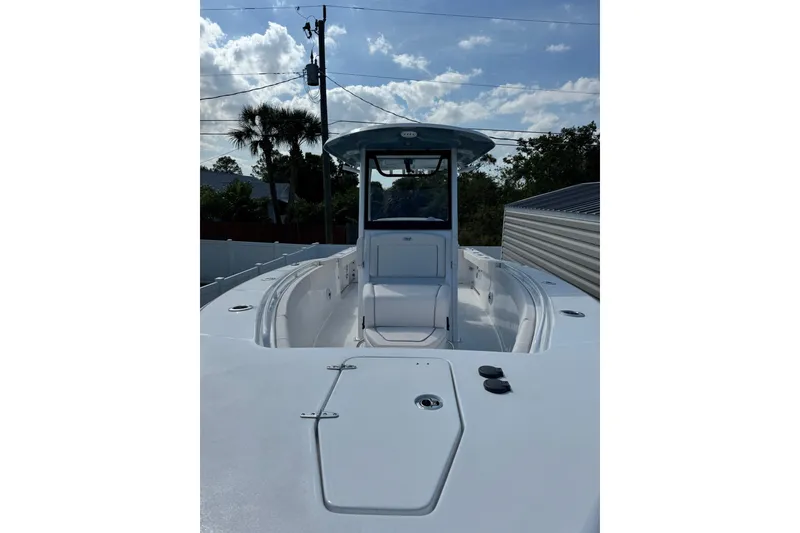 Slide: The Image of 2025 Sea Hunt Gamefish 27 Coffin Box boat, sleek design under a partly cloudy sky. - 12