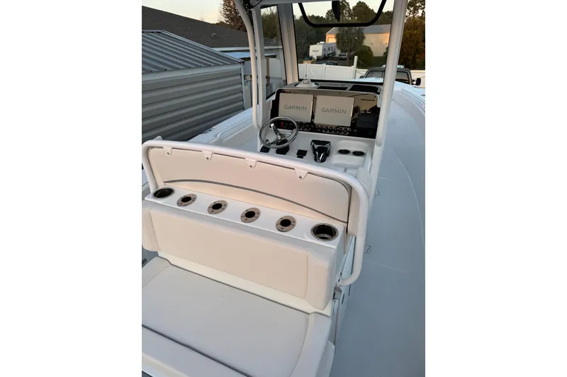 Slide: The Image of 2025 Sea Hunt Gamefish 27 Coffin Box boat interior with Garmin displays and seating. - 13
