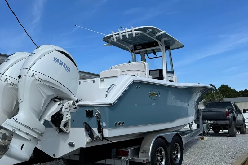 Slide: The Image of 2025 Sea Hunt Gamefish 27 Coffin Box boat with Yamaha engines on a trailer. - 3