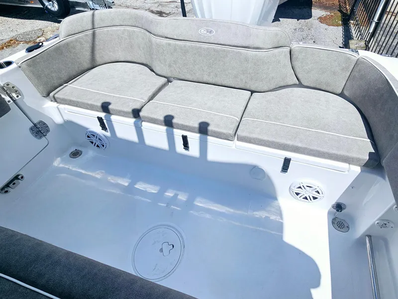 Slide: The Image of 2025 Sea Hunt Ultra 245 SE boat interior with cushioned seating and speakers. - 11
