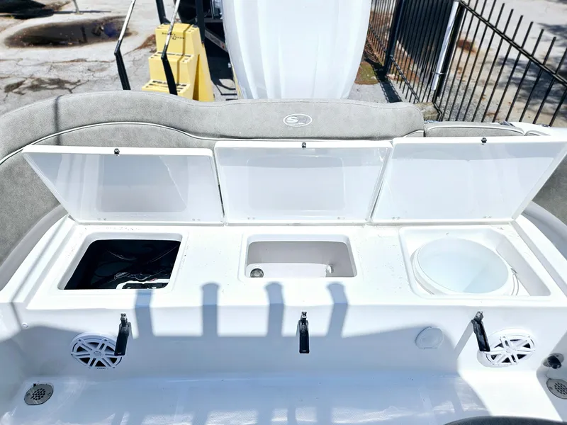 Slide: The Image of 2025 Sea Hunt Ultra 245 SE boat storage compartments and seating area. - 12