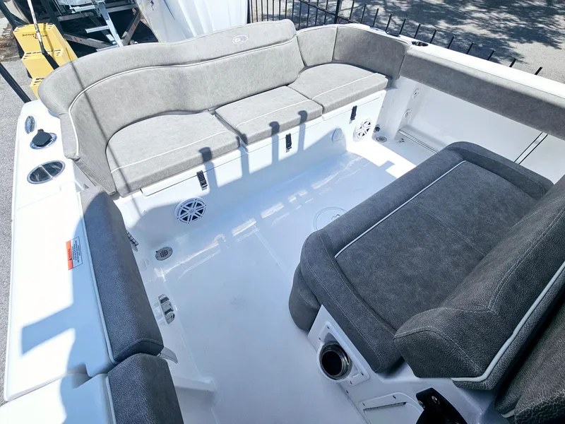 Slide: The Image of 2025 Sea Hunt Ultra 245 SE boat interior with gray seating and spacious deck. - 15