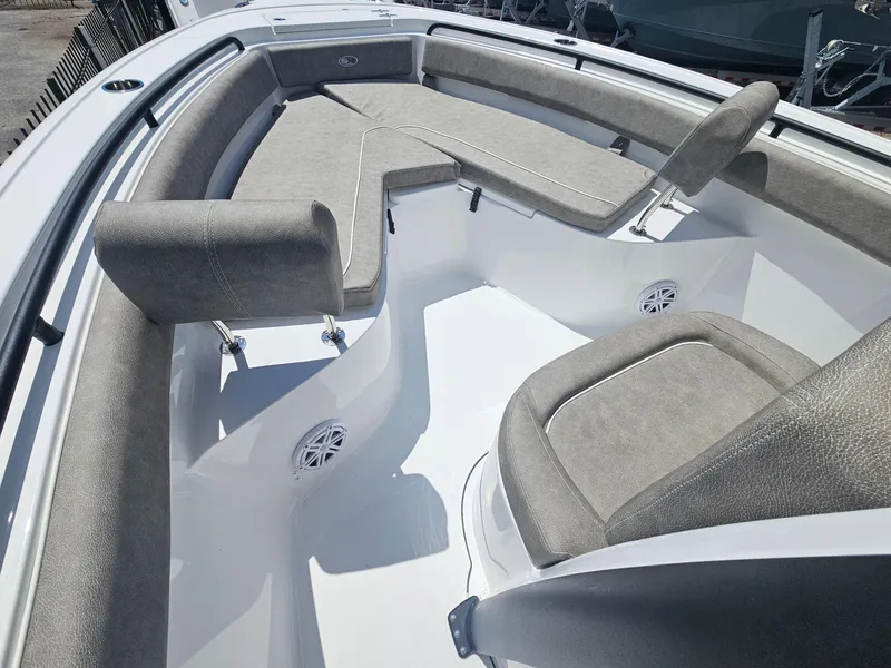 Slide: The Image of 2025 Sea Hunt Ultra 245 SE boat interior with cushioned seating and speakers. - 22
