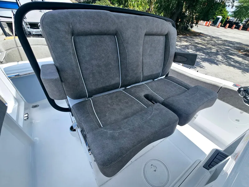 Slide: The Image of 2025 Sea Hunt Ultra 245 SE boat with plush gray seating in a sunny outdoor setting. - 26