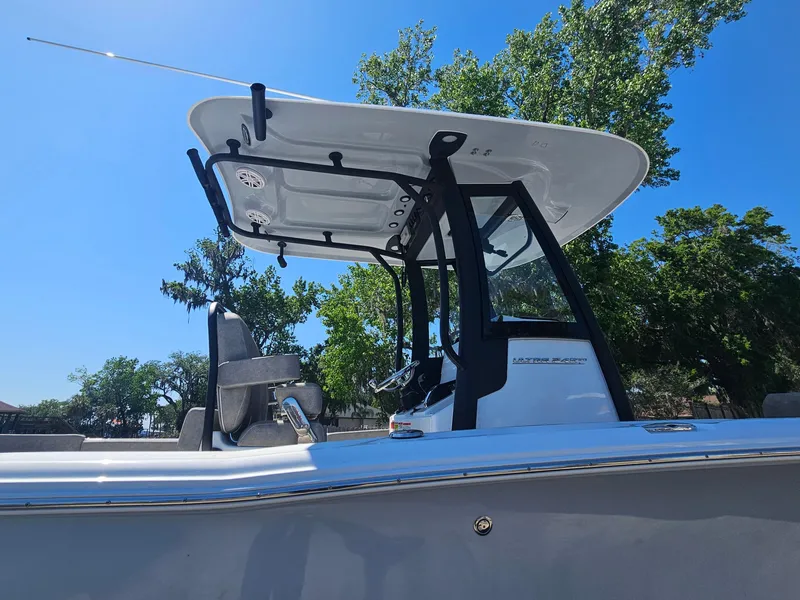 Slide: The Image of 2025 Sea Hunt Ultra 245 SE boat with T-top against a clear blue sky. - 5