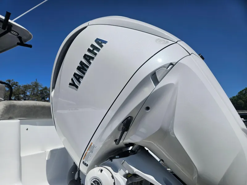 Slide: The Image of 2025 Sea Hunt Ultra 245 SE with Yamaha outboard motor, under clear blue sky. - 8