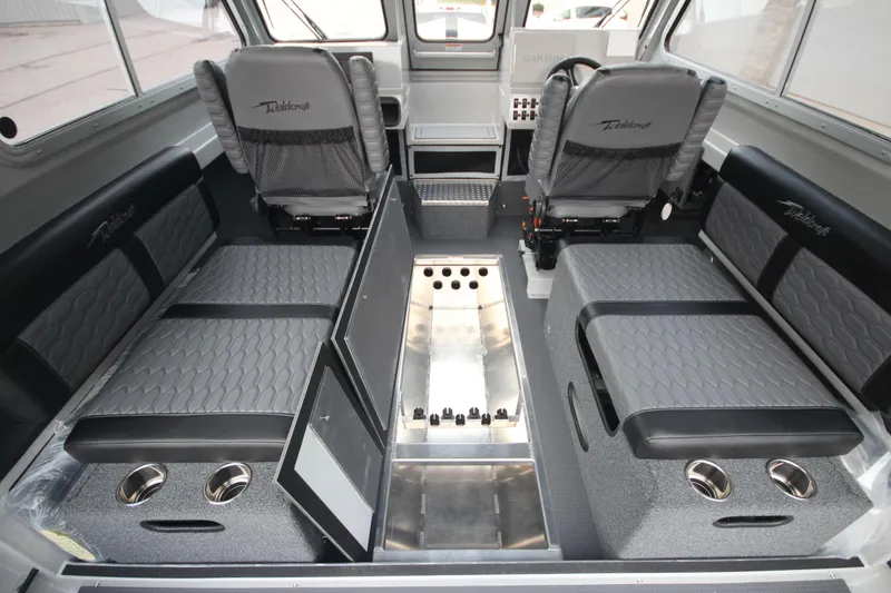 Slide: The Image of 2026 Weldcraft 240 Ocean King F300XCB boat interior with seating and storage. - 15