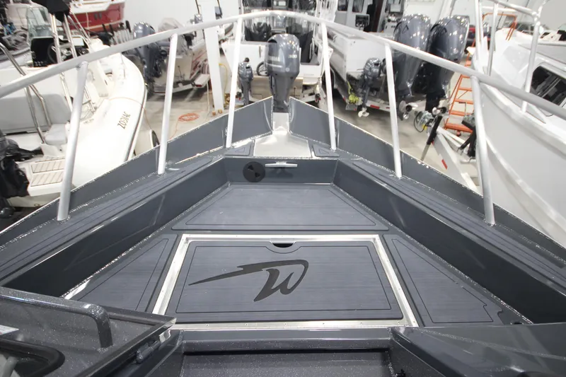 Slide: The Image of 2026 Weldcraft 240 Ocean King F300XCB boat deck in showroom, surrounded by other boats. - 32