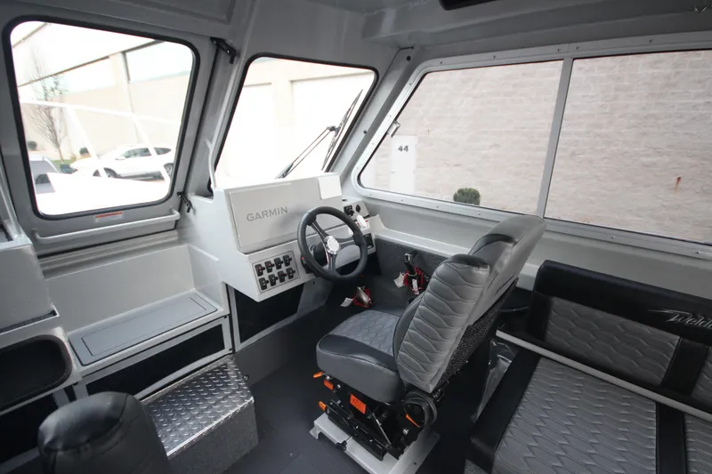 Slide: The Image of Interior of 2026 Weldcraft 240 Ocean King F300XCB boat, featuring spacious seating and clear dividers. - 17