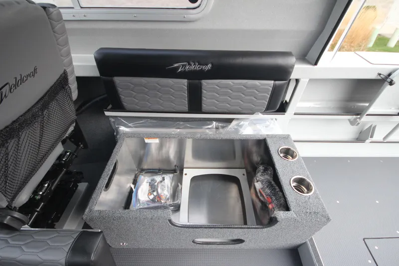 Slide: The Image of Interior of 2026 Weldcraft 240 Ocean King F300XCB boat, featuring seating and dashboard. - 25