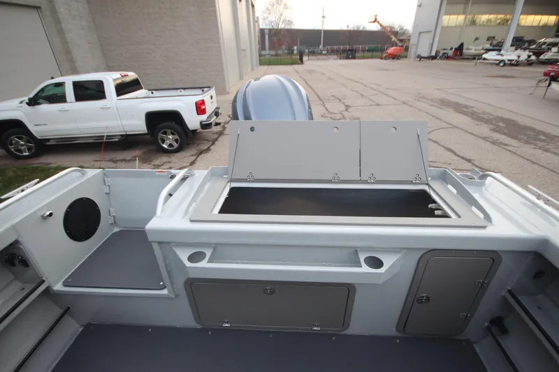 Slide: The Image of 2026 Weldcraft 240 Ocean King F300XCB boat in showroom, surrounded by other vessels. - 7