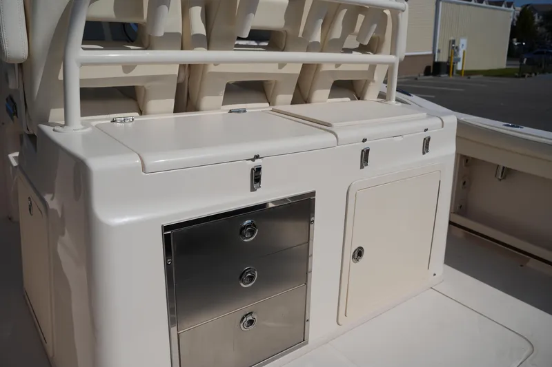 Slide: The Image of 2021 Grady-White Canyon 326 boat interior with storage compartments and seating. - 12