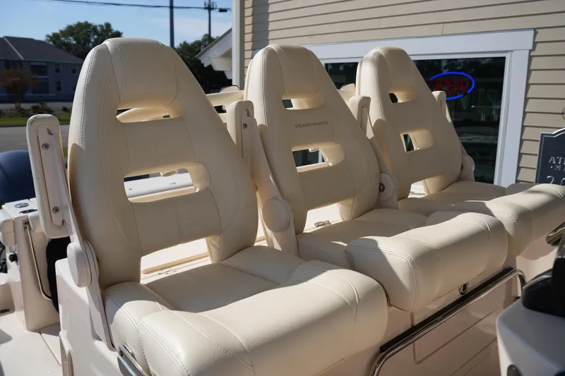 Slide: The Image of 2021 Grady-White Canyon 326 boat seats, beige leather, outdoor setting. - 16