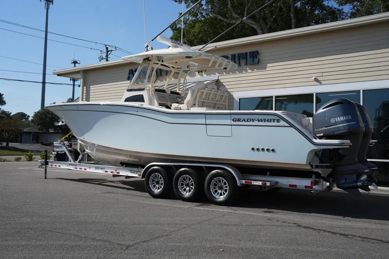Slide: The Image of 2021 Grady-White Canyon 326 boat on trailer outside dealership. - 2