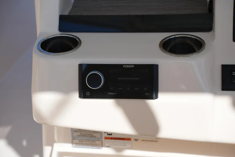 Slide: The Image of 2021 Grady-White Canyon 326 boat console with Fusion stereo system and cup holders. - 22