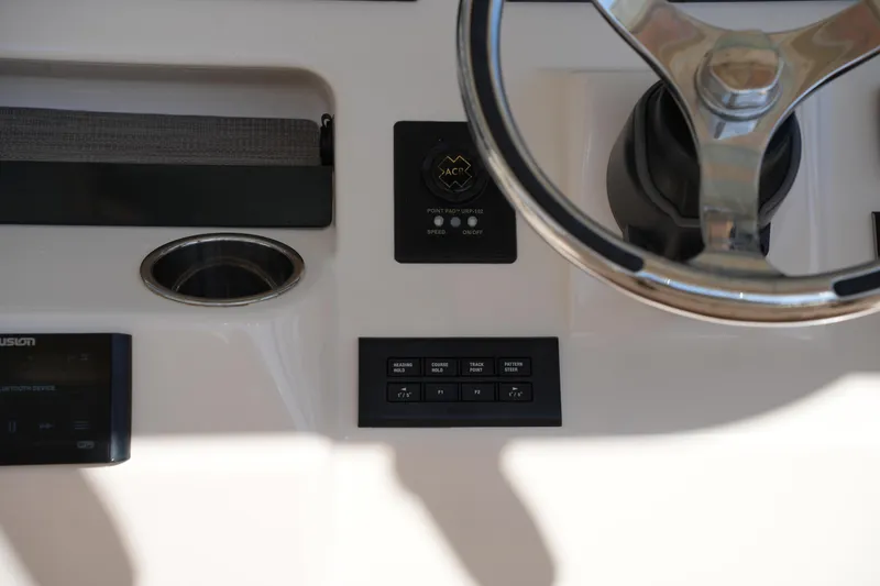 Slide: The Image of 2021 Grady-White Canyon 326 boat dashboard with steering wheel and control panel. - 23