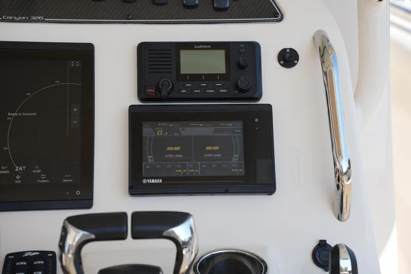 Slide: The Image of Control panel of 2021 Grady-White Canyon 326 boat with Garmin and Yamaha displays. - 25