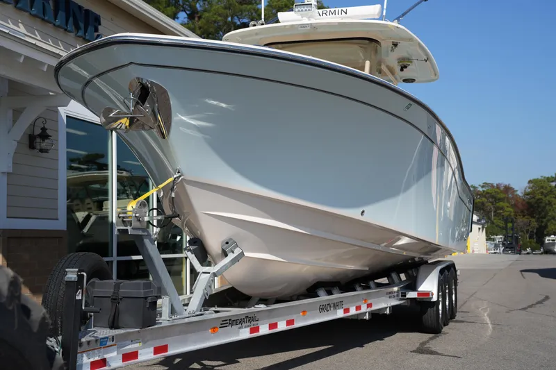 Slide: The Image of 2021 Grady-White Canyon 326 boat on trailer, parked outside a building. - 3