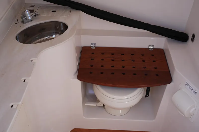 Slide: The Image of 2021 Grady-White Canyon 326 boat interior with sink and covered toilet. - 31