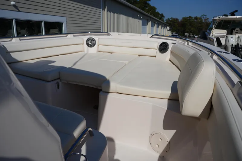 Slide: The Image of 2021 Grady-White Canyon 326 boat interior with cushioned seating and speakers. - 34