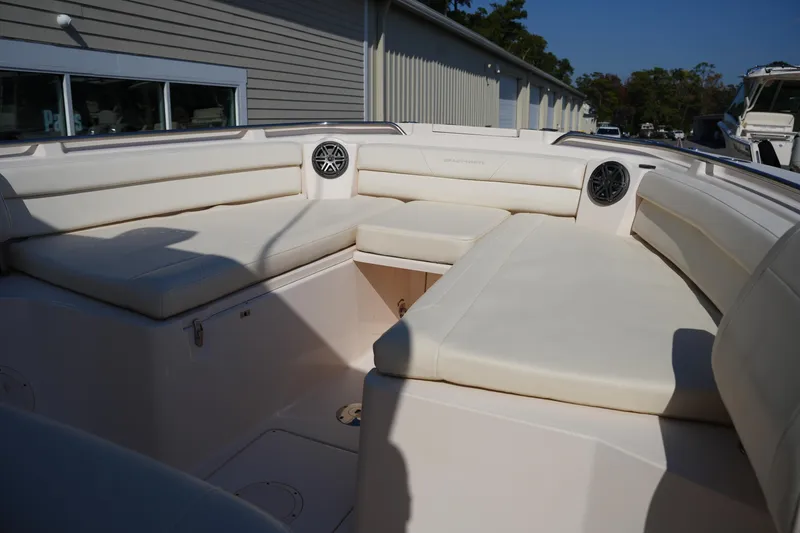 Slide: The Image of 2021 Grady-White Canyon 326 boat interior with cushioned seating and speakers. - 35