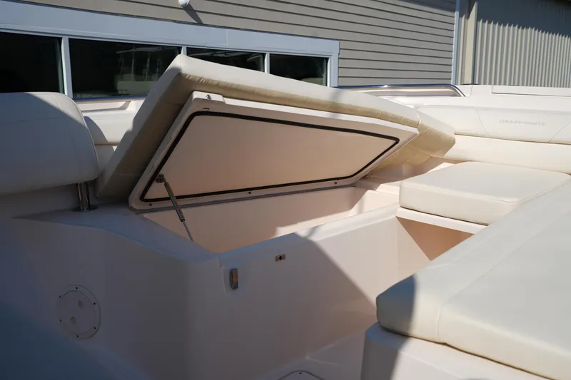 Slide: The Image of 2021 Grady-White Canyon 326 boat with open storage compartment and cushioned seating. - 36